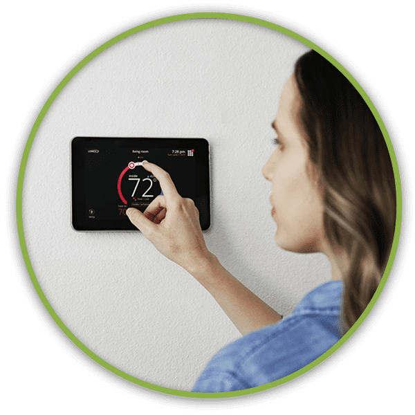 Woman adjusting her thermostat