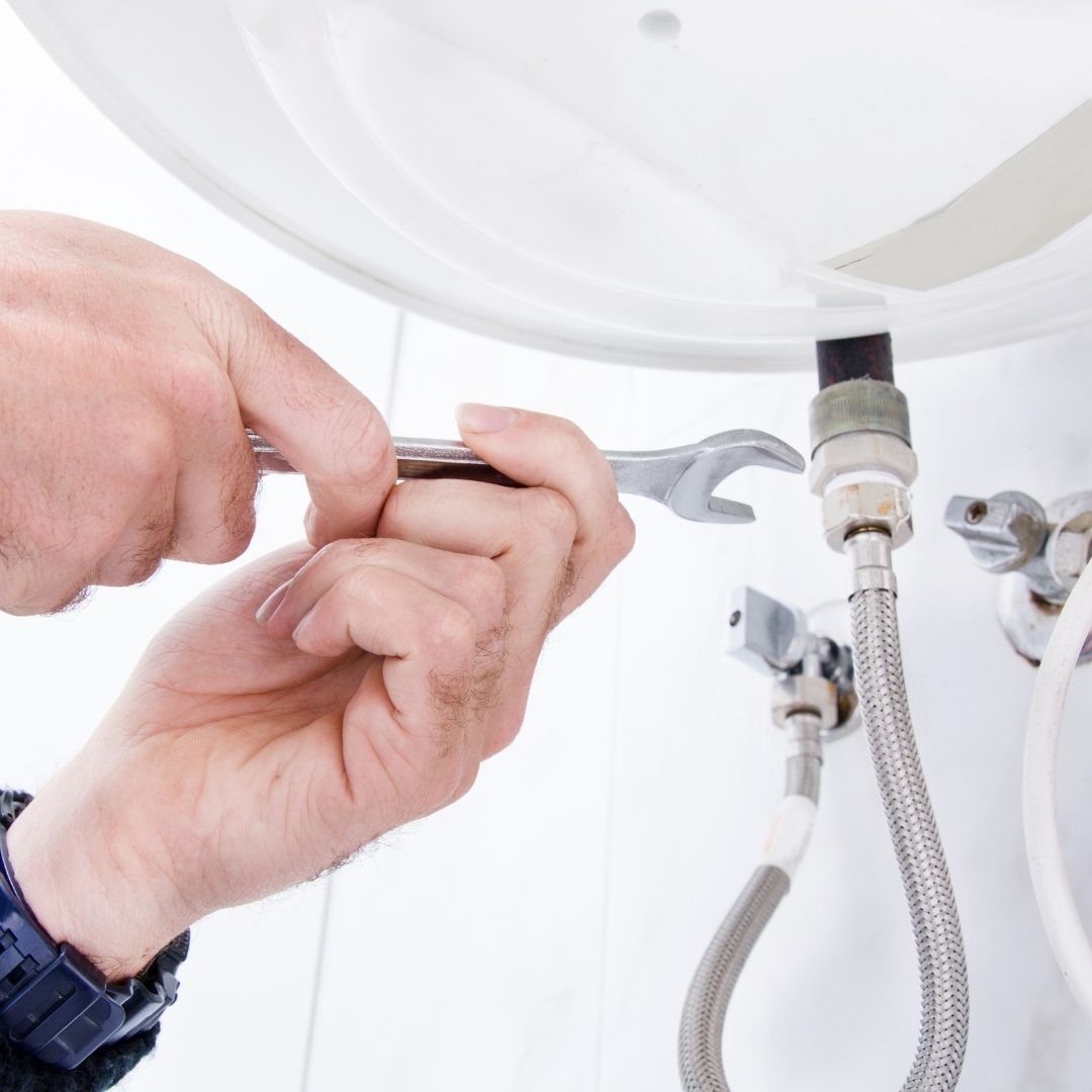 plumber working on sink