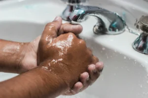 Hands being washed in a sink